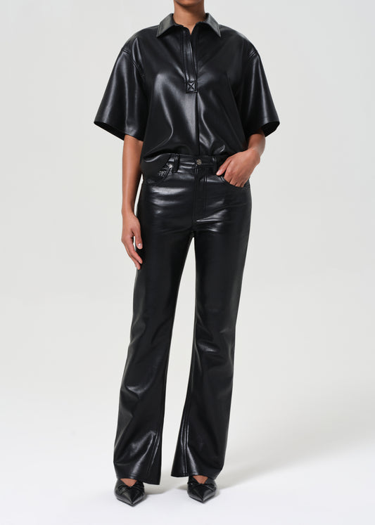 Person wearing a black leather outfit on a white background