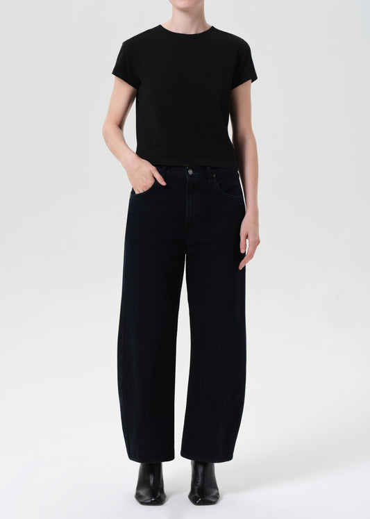 Person wearing a black t-shirt and black pants on a white background