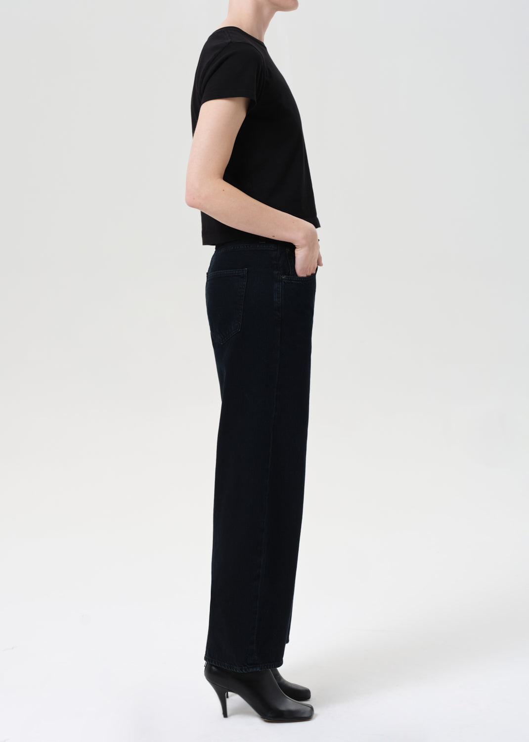 Person wearing a black outfit on a white background