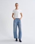 Person wearing a white t-shirt and blue jeans on a white background
