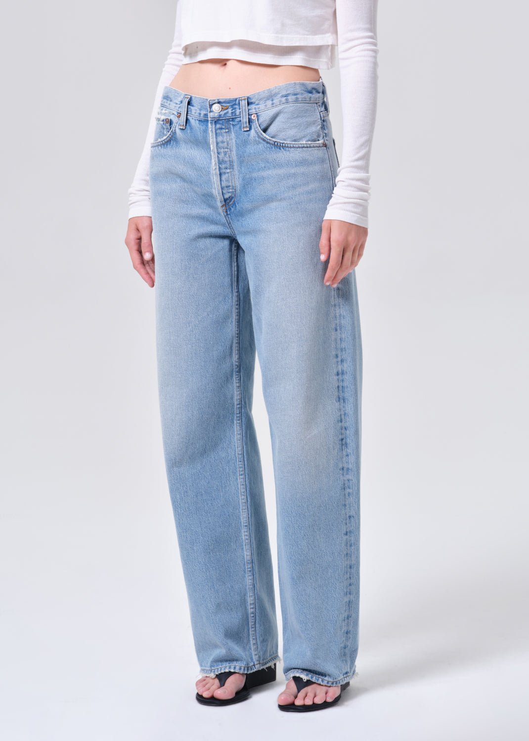 Light blue jeans worn by a person on a white background