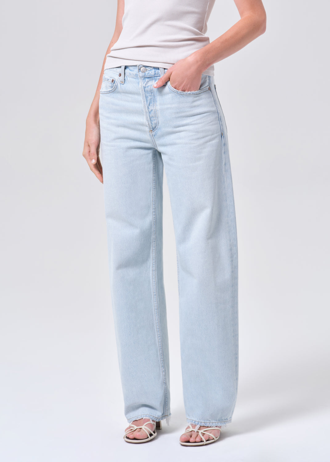 Light blue jeans worn by a person on a white background