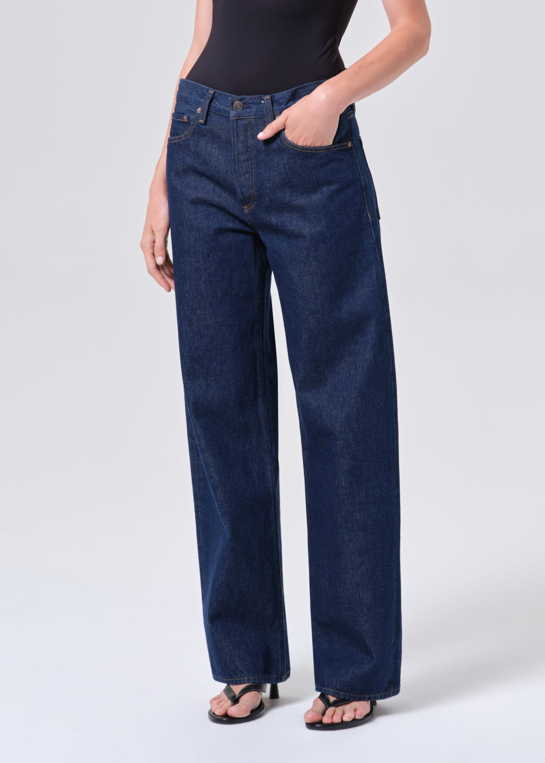 Person wearing blue jeans on a white background