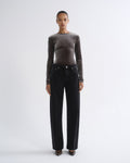 Person wearing brown long sleeve top and black jeans, front view