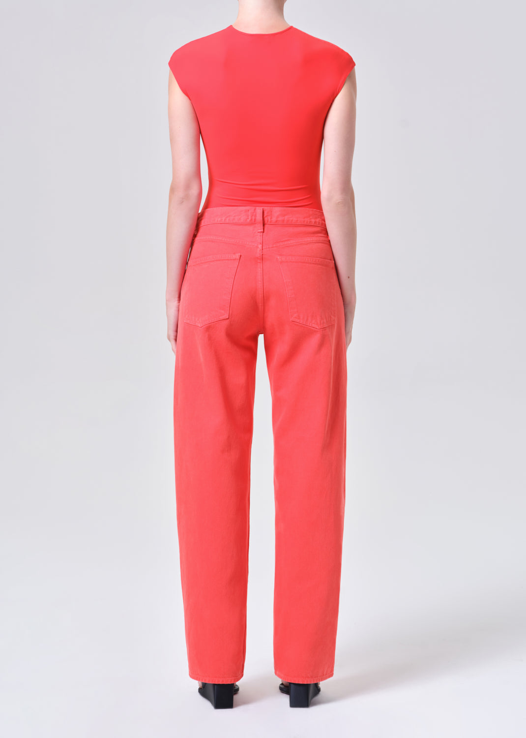 Person wearing a red jumpsuit on a white background