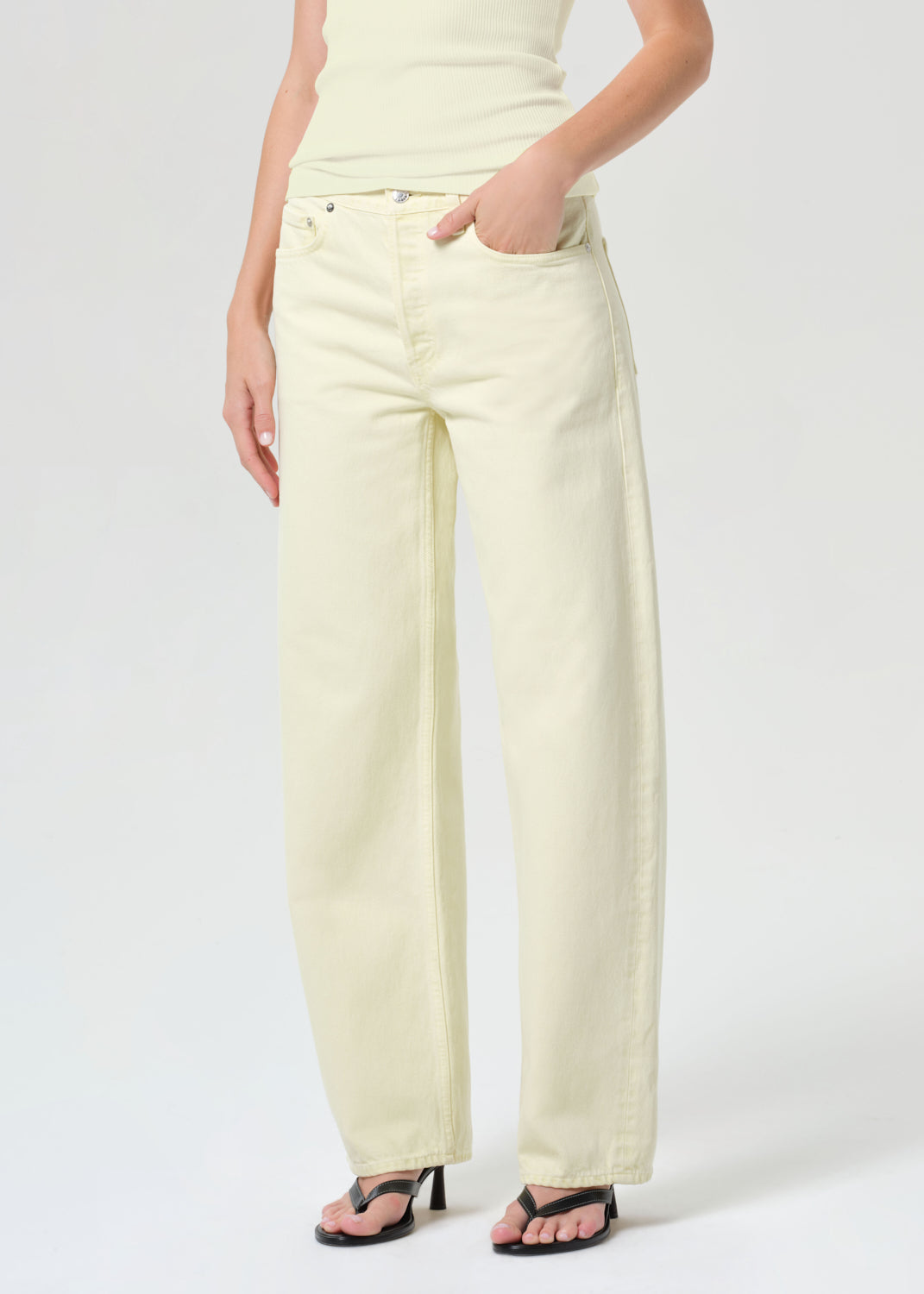 Person wearing light-colored pants on a white background