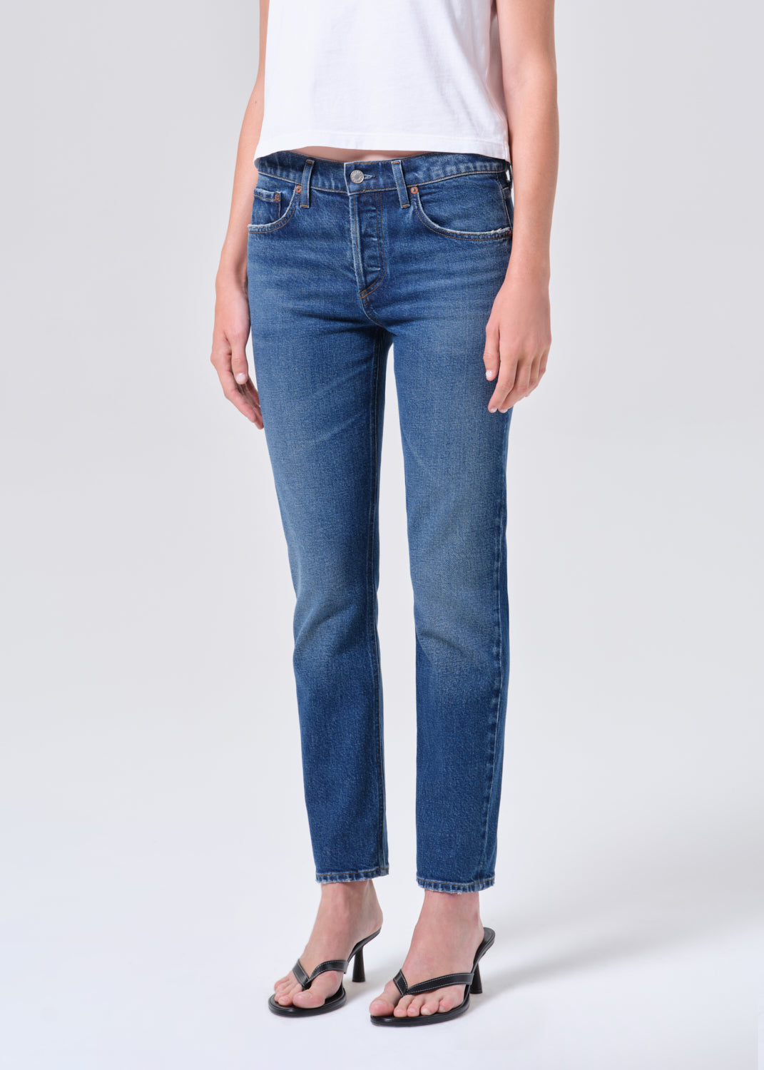 Person wearing blue jeans on a white background