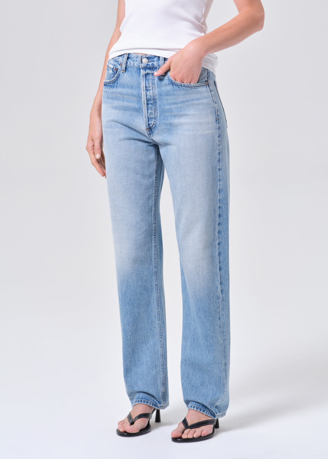 Light blue jeans worn by a person on a white background