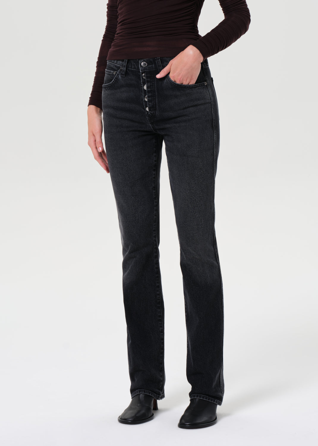 Person wearing black jeans on a white background