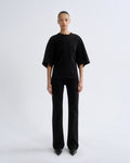 Person wearing a black outfit on a white background