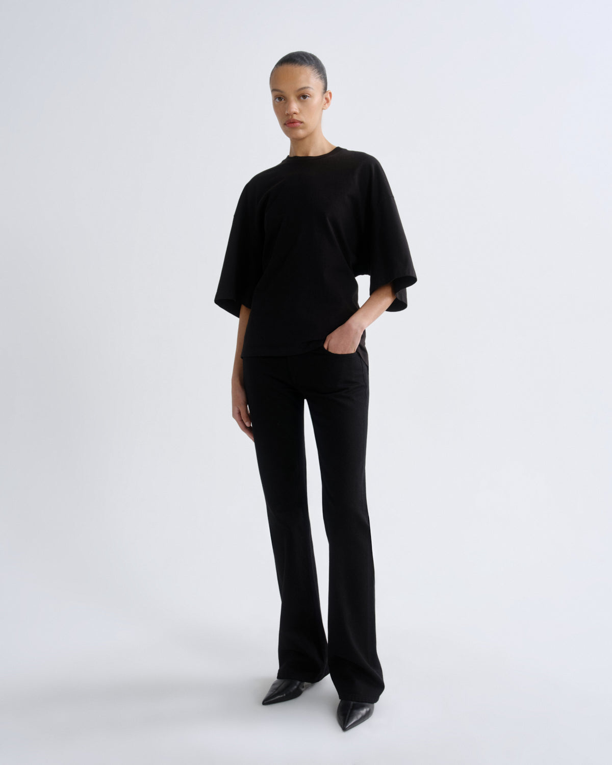 Person wearing a black outfit on a white background