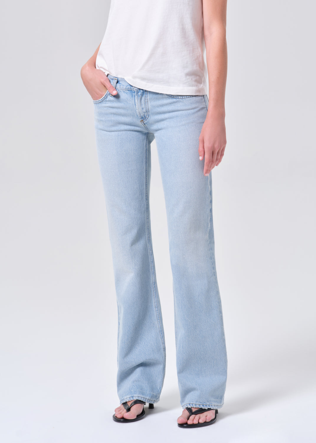 Light blue jeans worn by a person on a white background