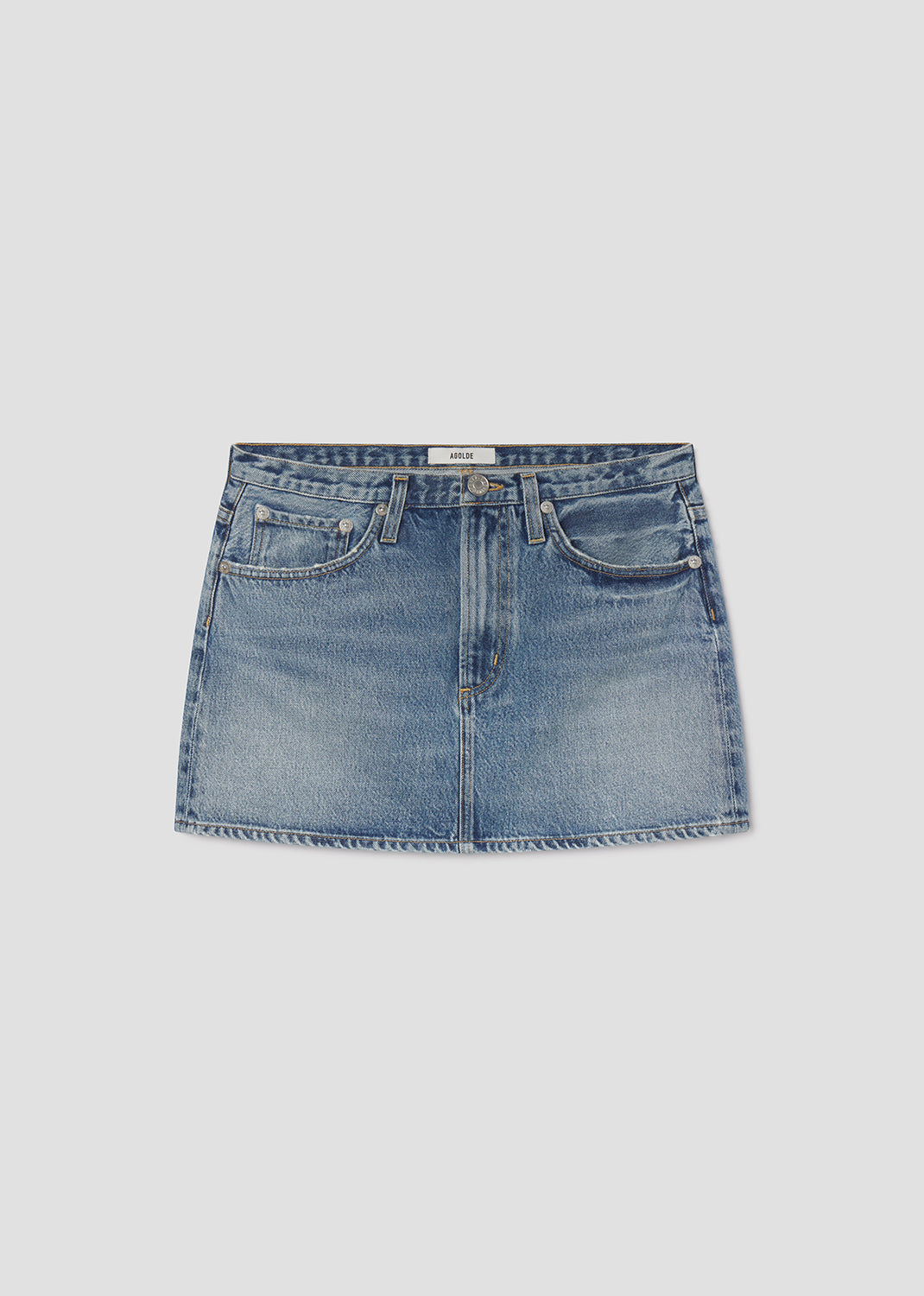 Blue denim skirt on a light gray background