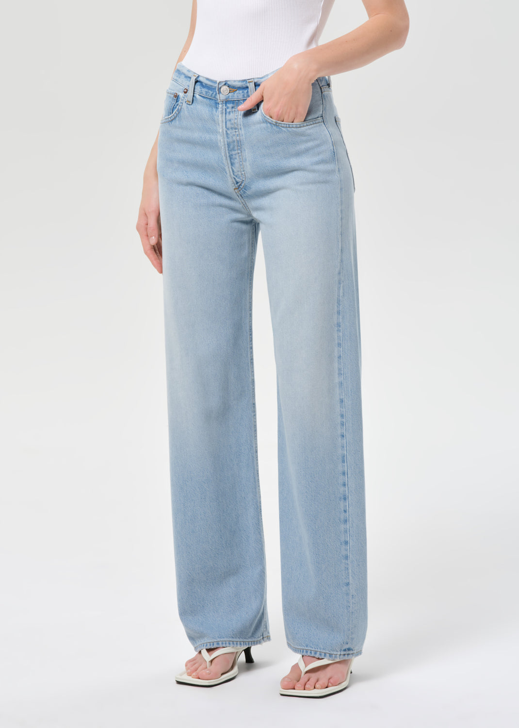 Light blue jeans worn by a person on a white background