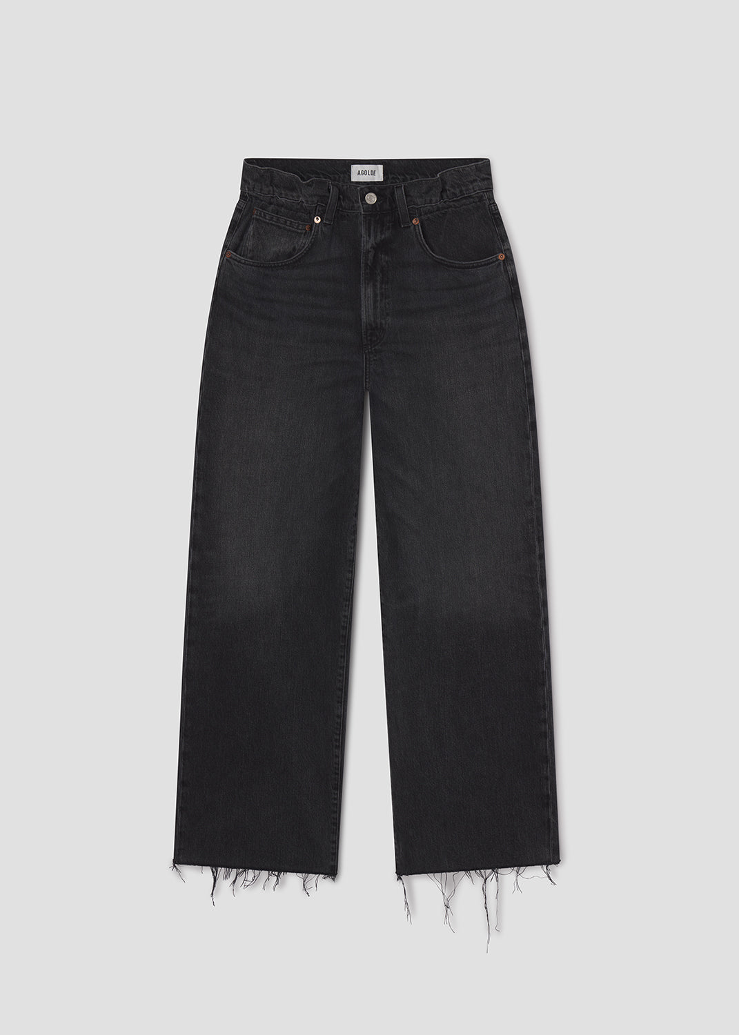 Black jeans with frayed hems on a light gray background