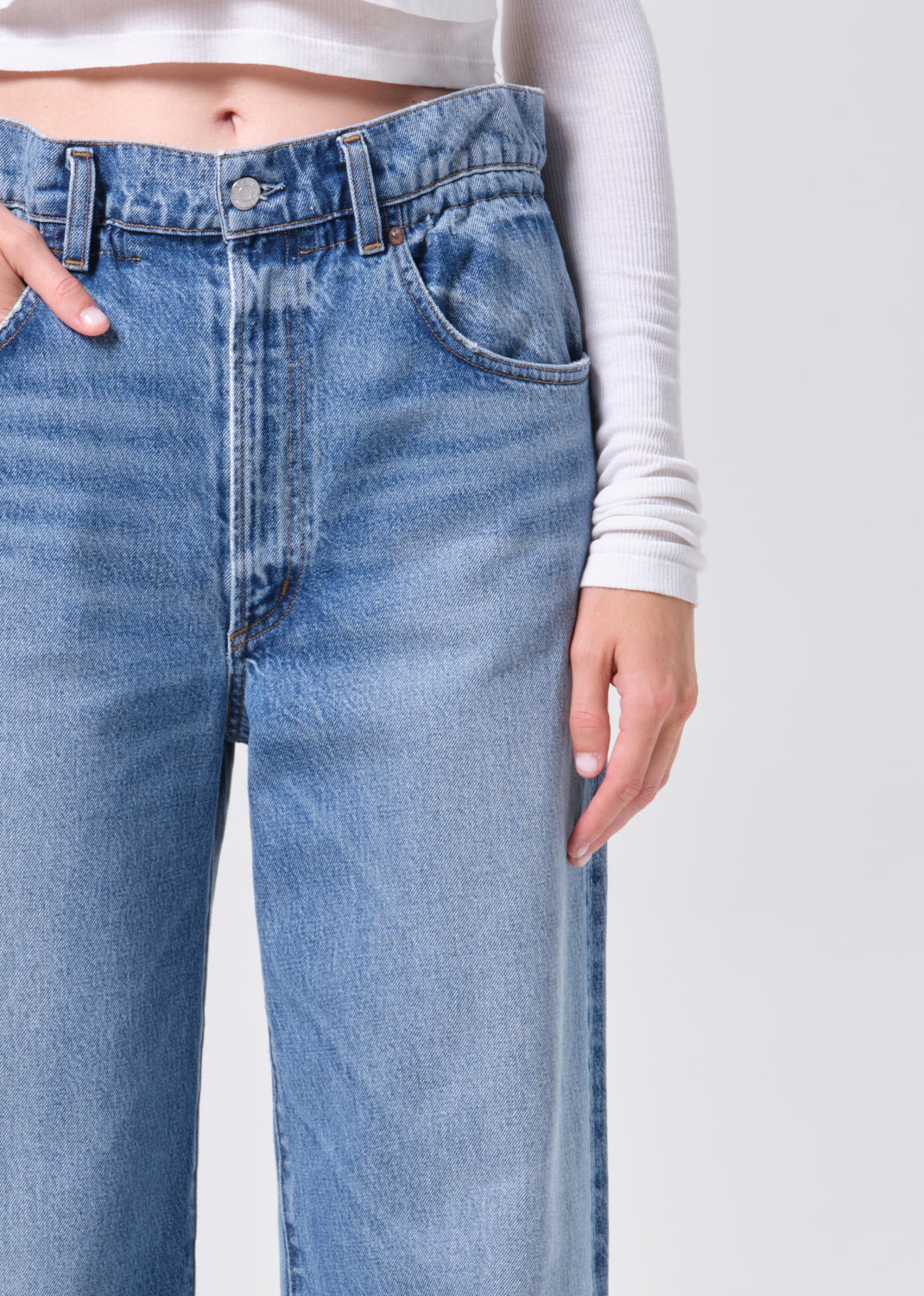Close-up of blue jeans with a plain background