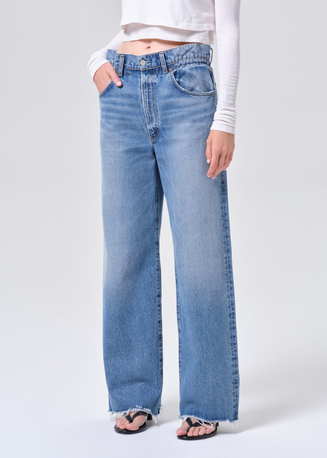 Light blue jeans worn by a person on a white background