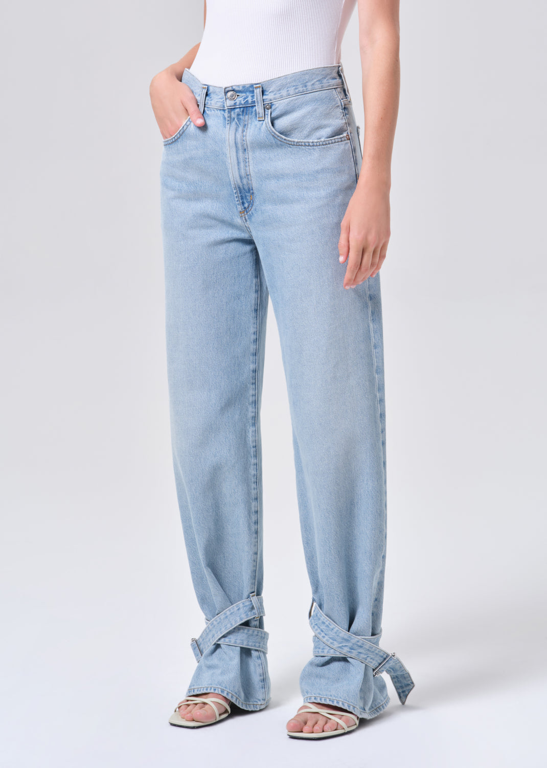 Light blue jeans worn by a person on a white background