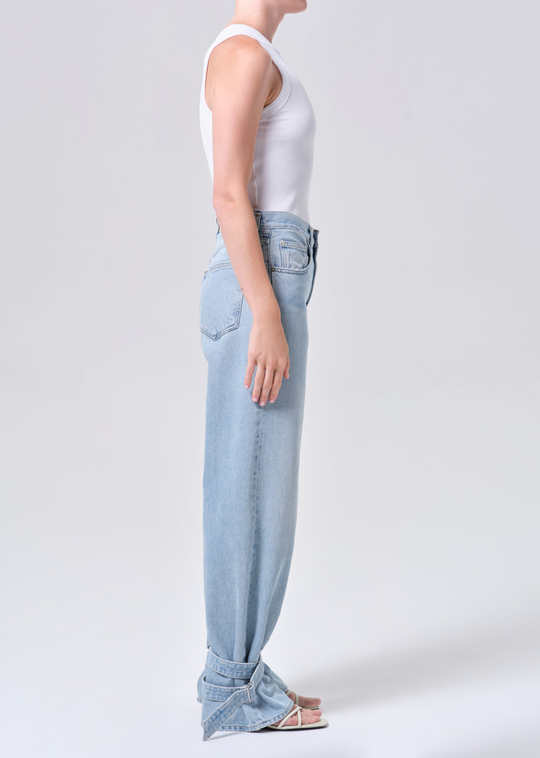 Light blue jeans worn by a person on a white background