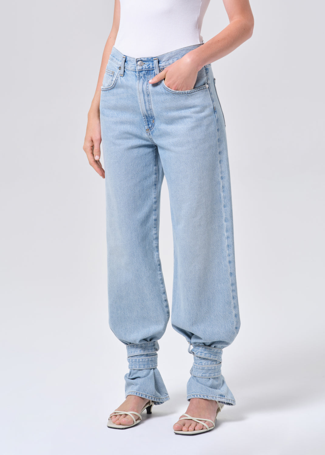 Light blue jeans worn by a person on a white background