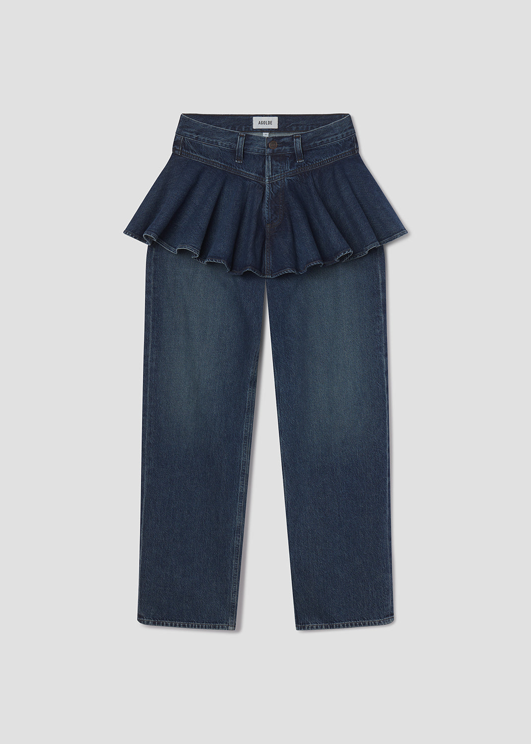 Dark blue jeans with a peplum waist on a light gray background