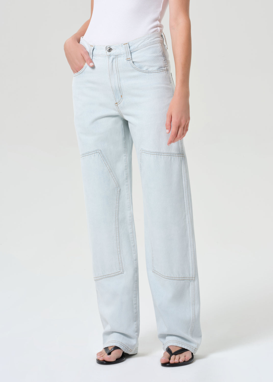 Light blue jeans worn by a person on a white background
