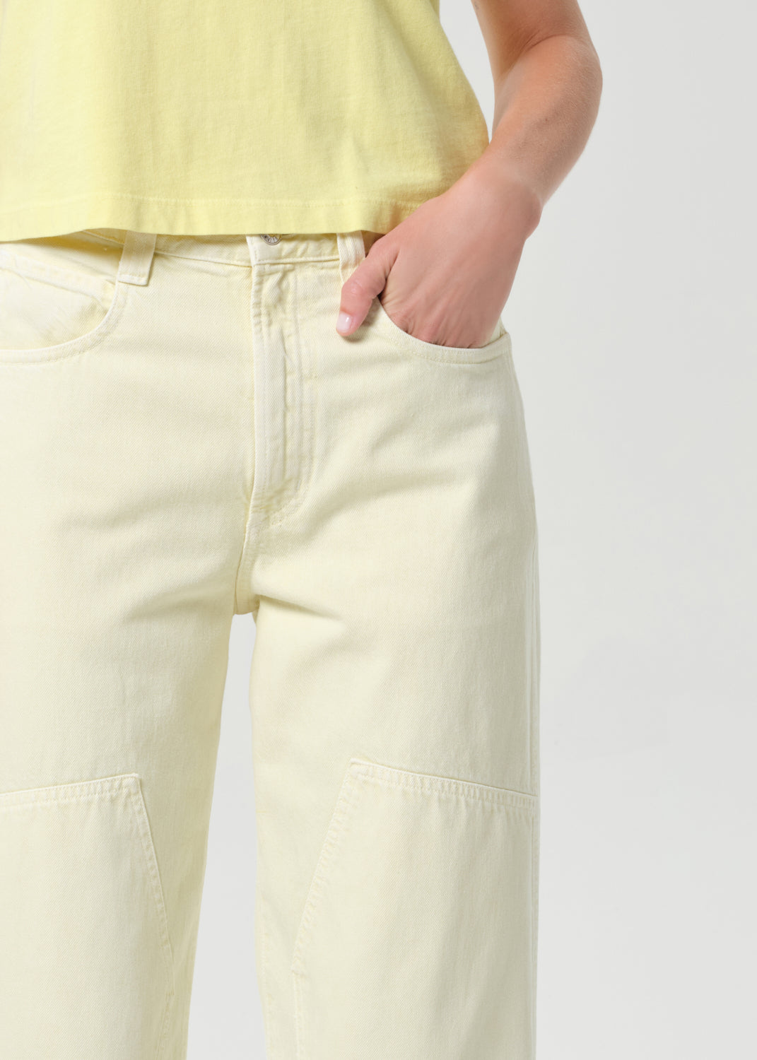 Light yellow pants worn by a person on a white background