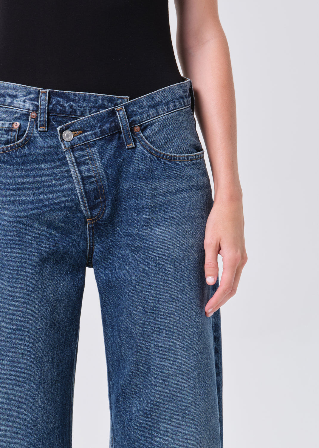 Close-up of blue jeans on a plain background