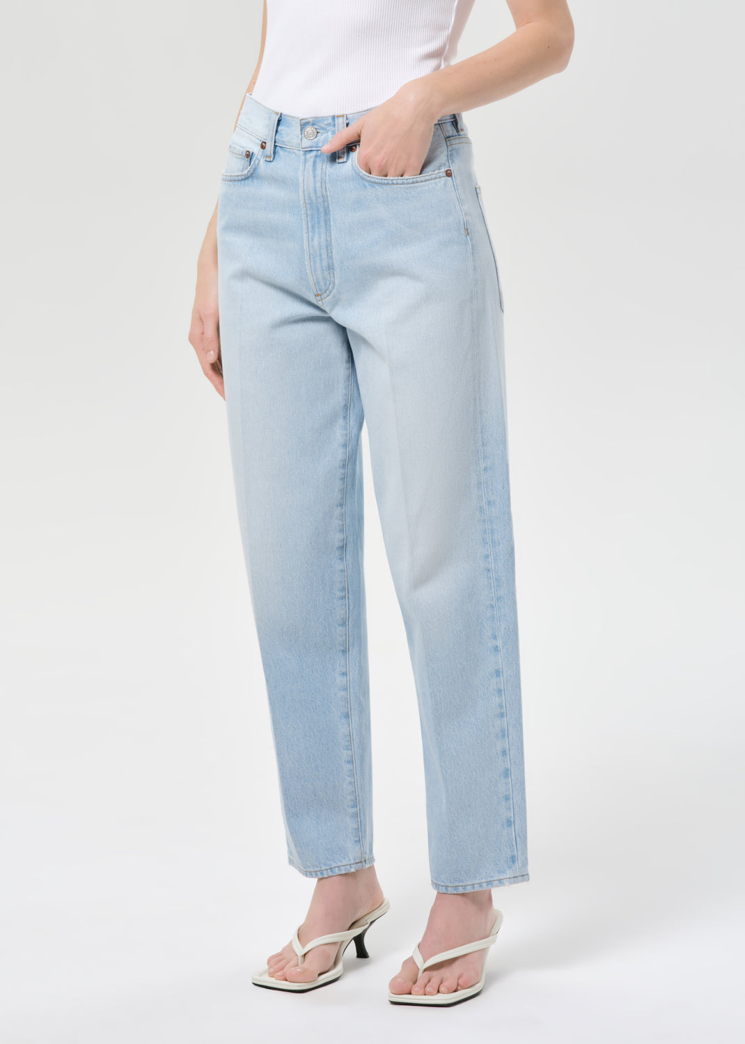 Light blue jeans worn by a person on a white background