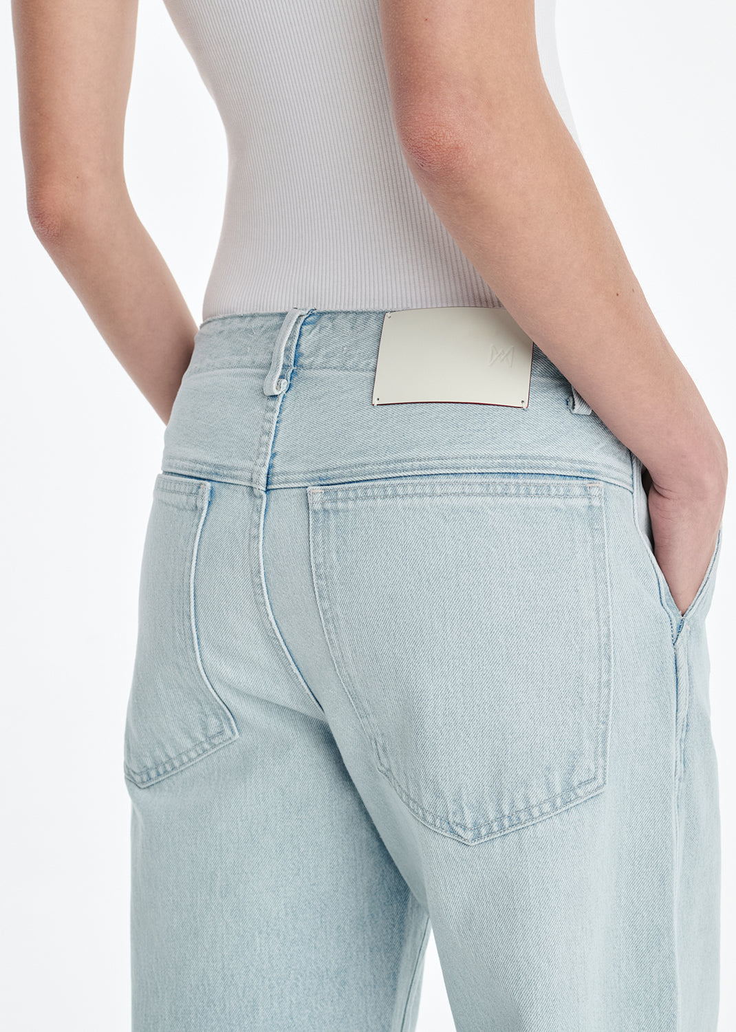 Light blue jeans worn by a person on a white background