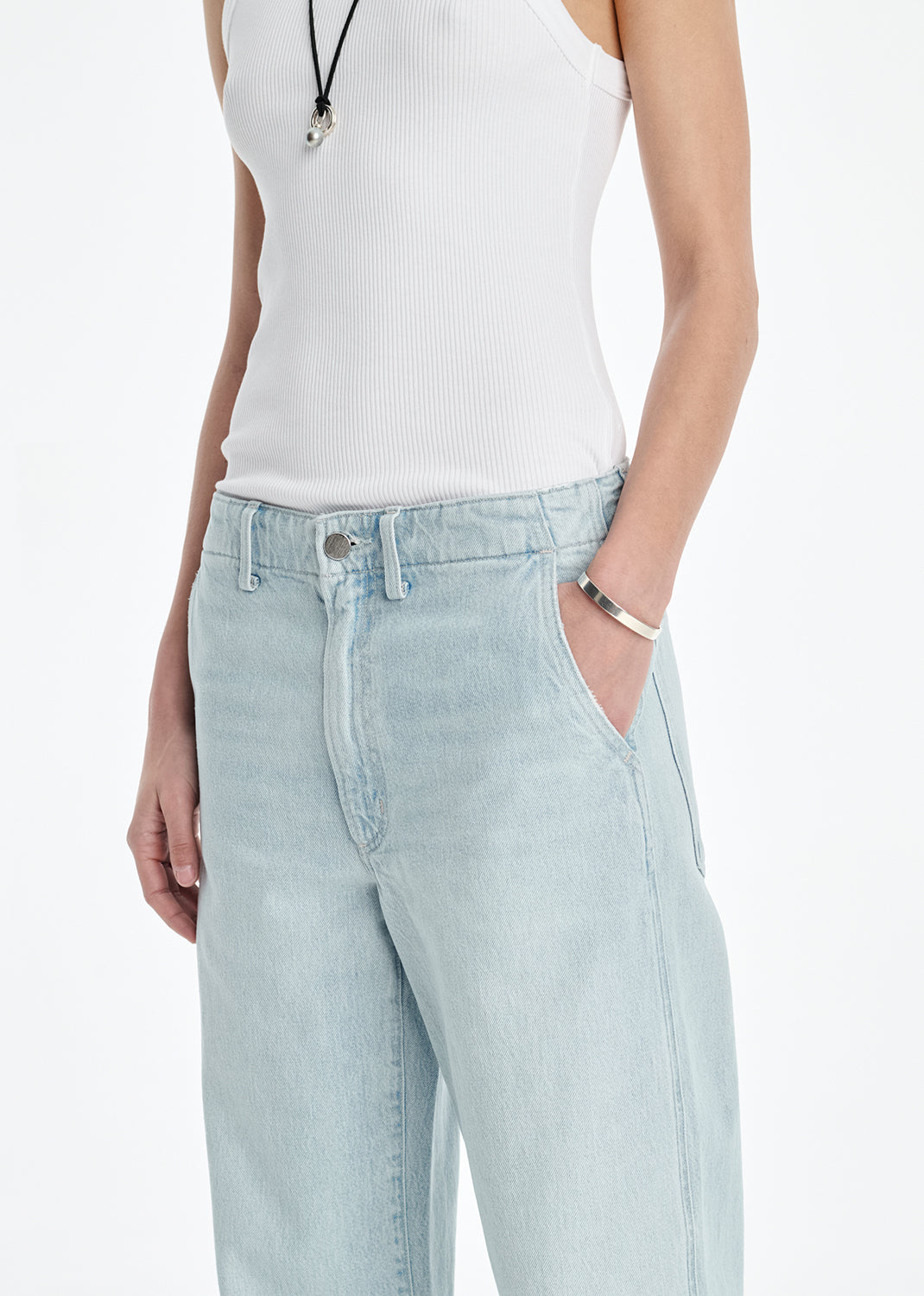 Light blue jeans worn by a person on a white background