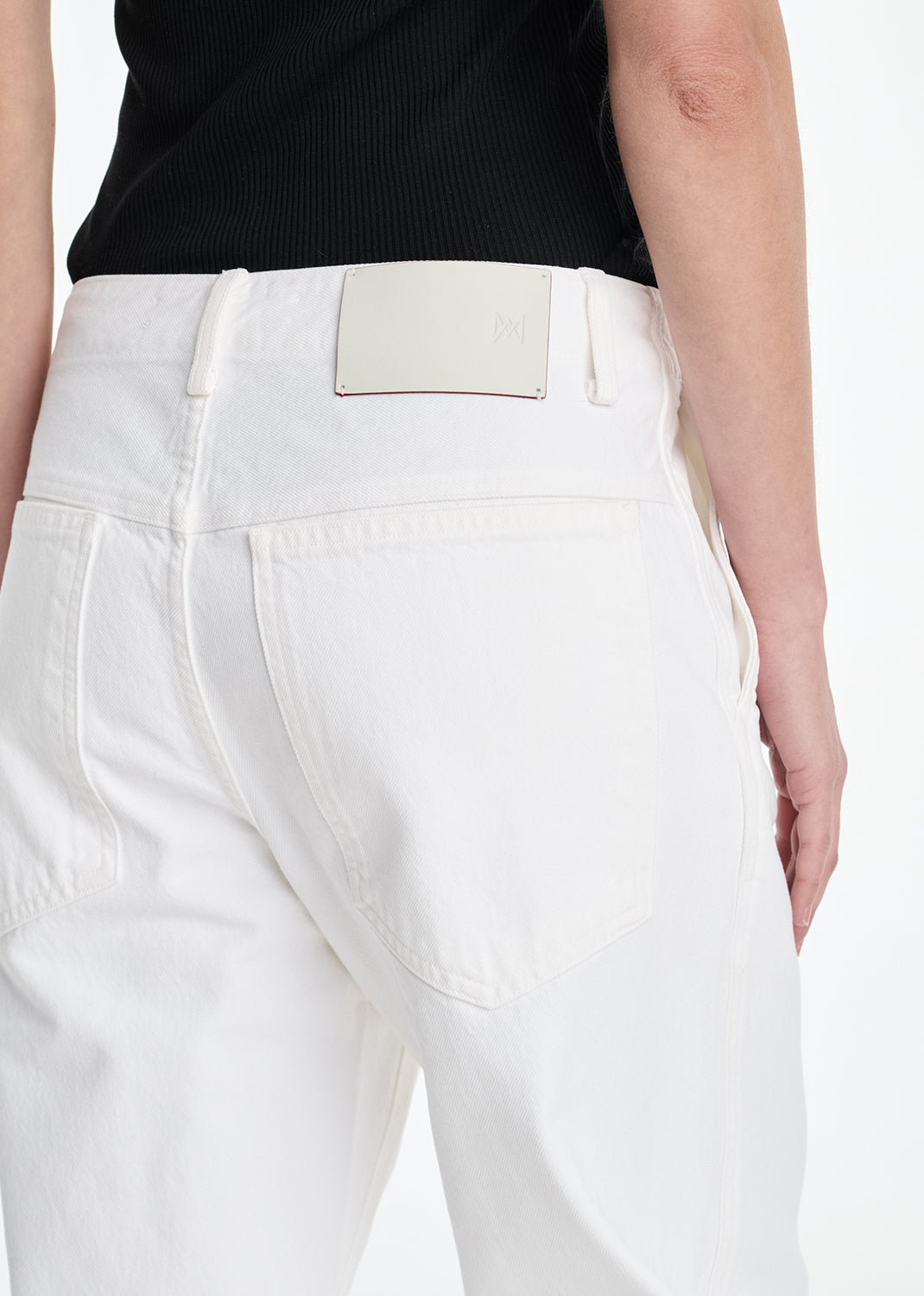 White pants with a visible brand label on a white background