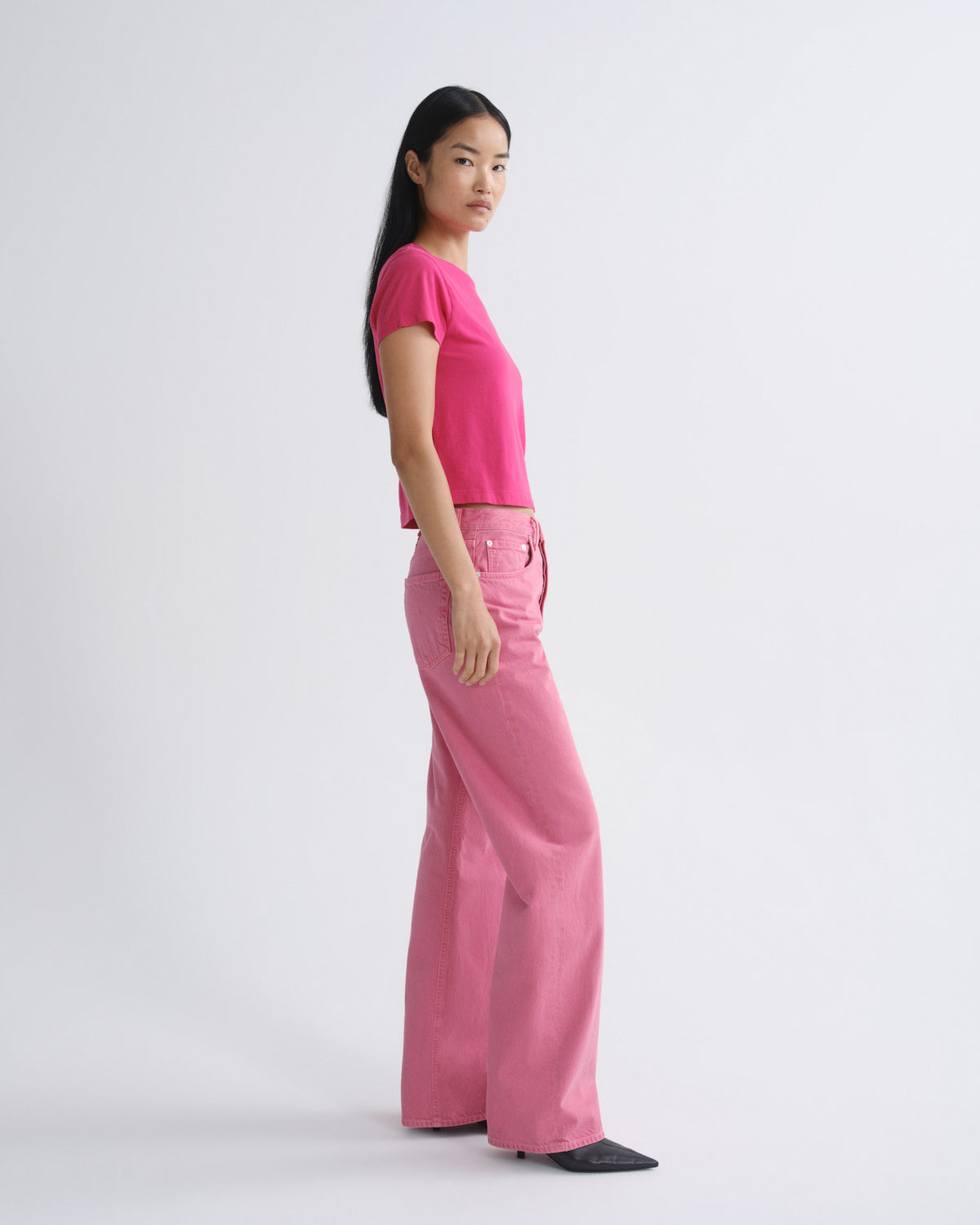Person wearing a pink outfit on a white background