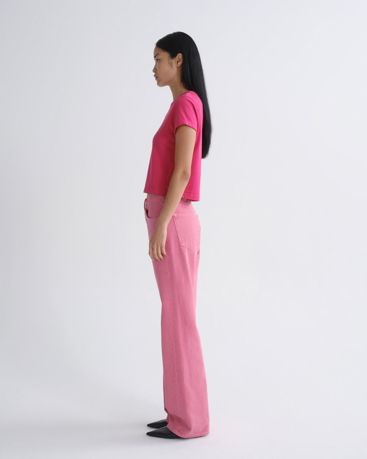 Person wearing a pink outfit on a white background