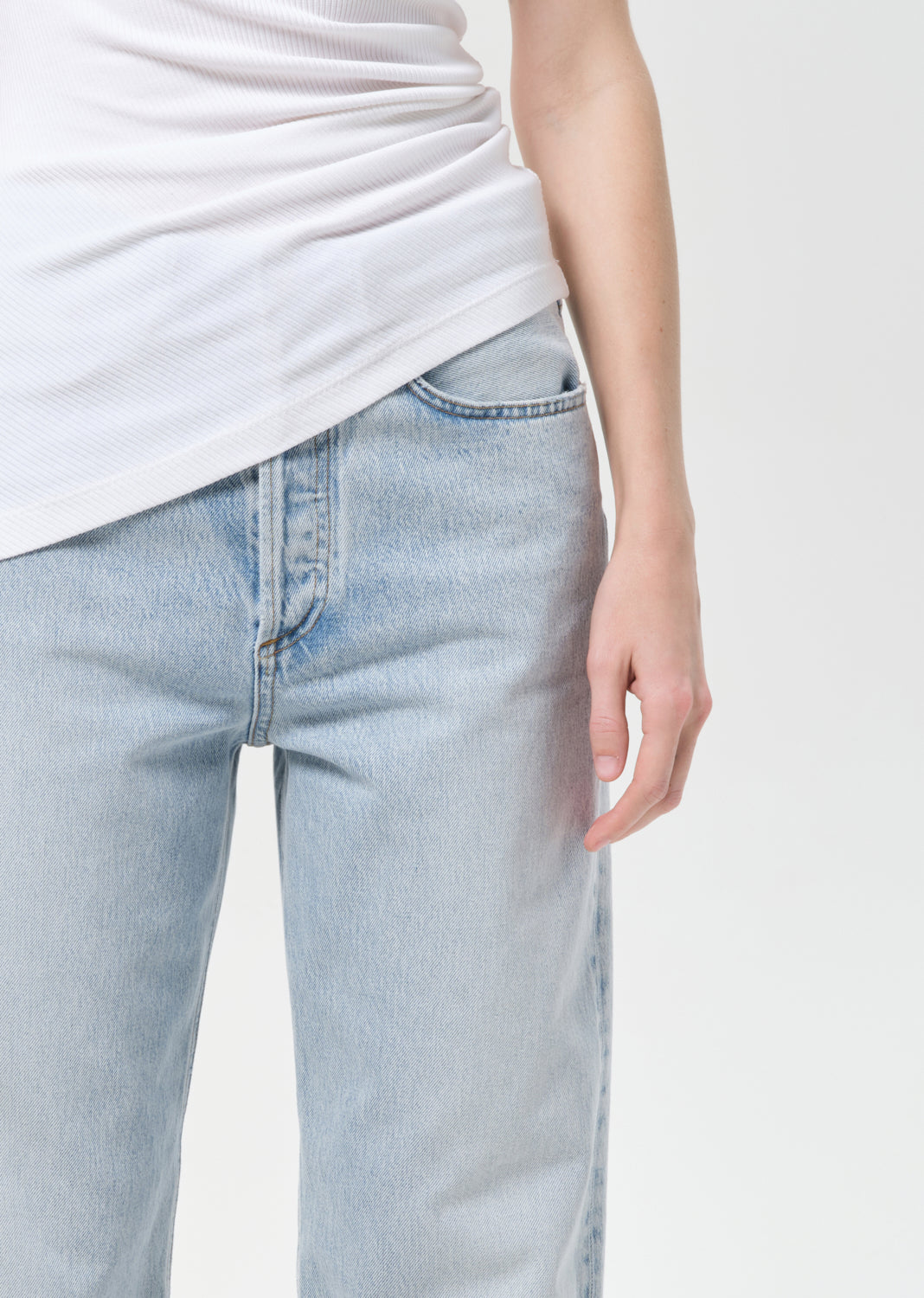 Light blue jeans worn by a person on a white background