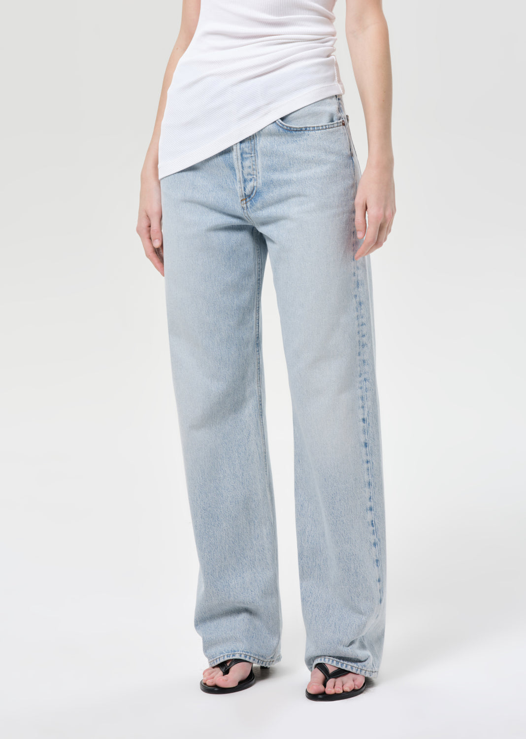Light blue jeans worn by a person on a white background