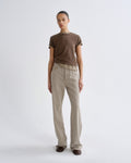 A model stands against a light gray studio background wearing a brown short-sleeve crewneck t-shirt and light beige straight-leg jeans.