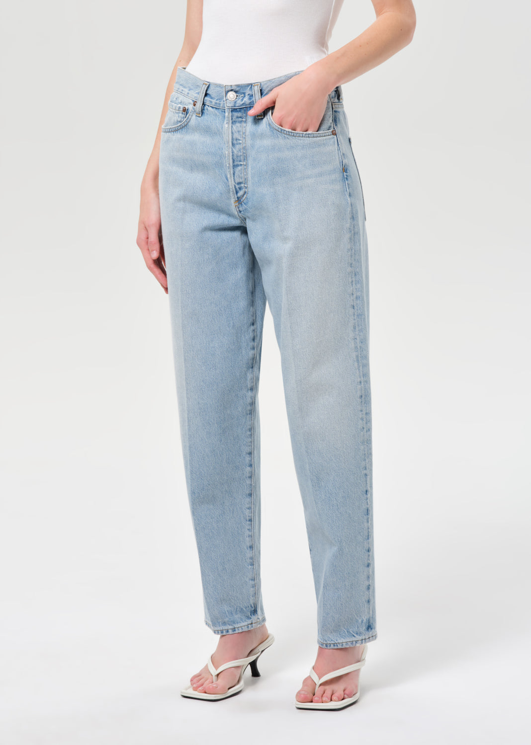 Light blue jeans worn by a person on a white background