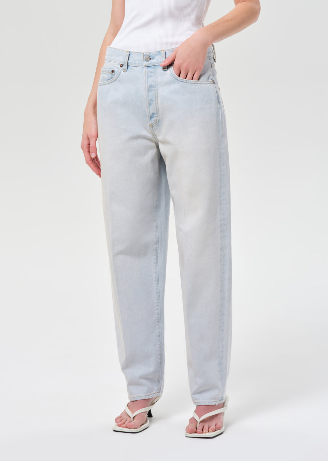 Light blue jeans worn by a person on a white background