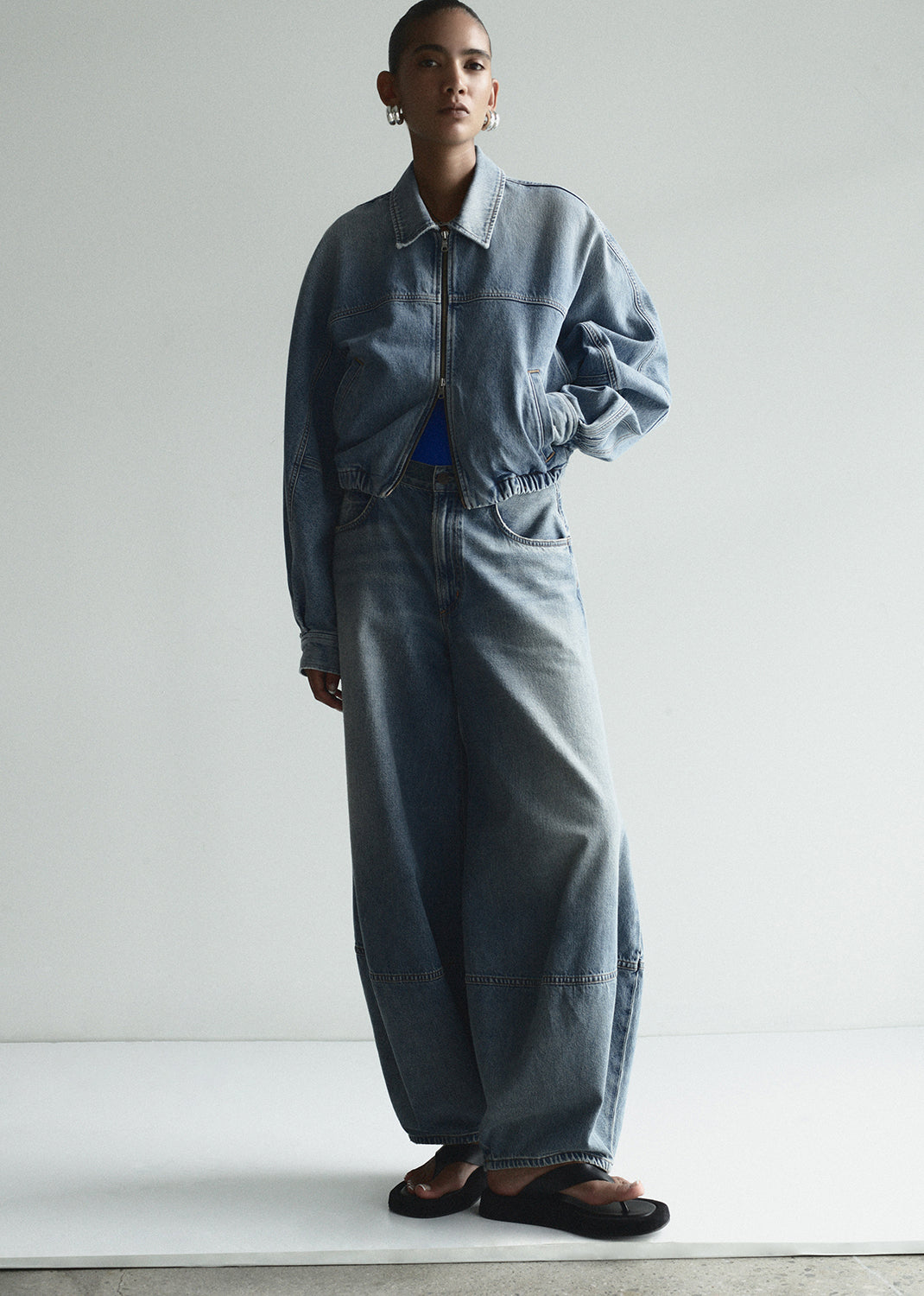 Person wearing a denim outfit against a white background