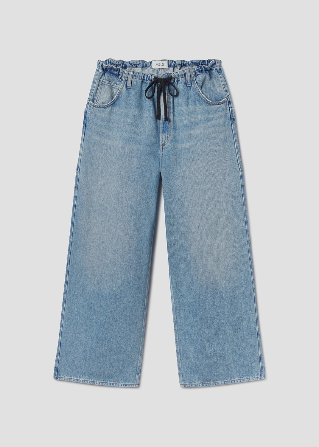 Blue jeans with a drawstring on a light gray background