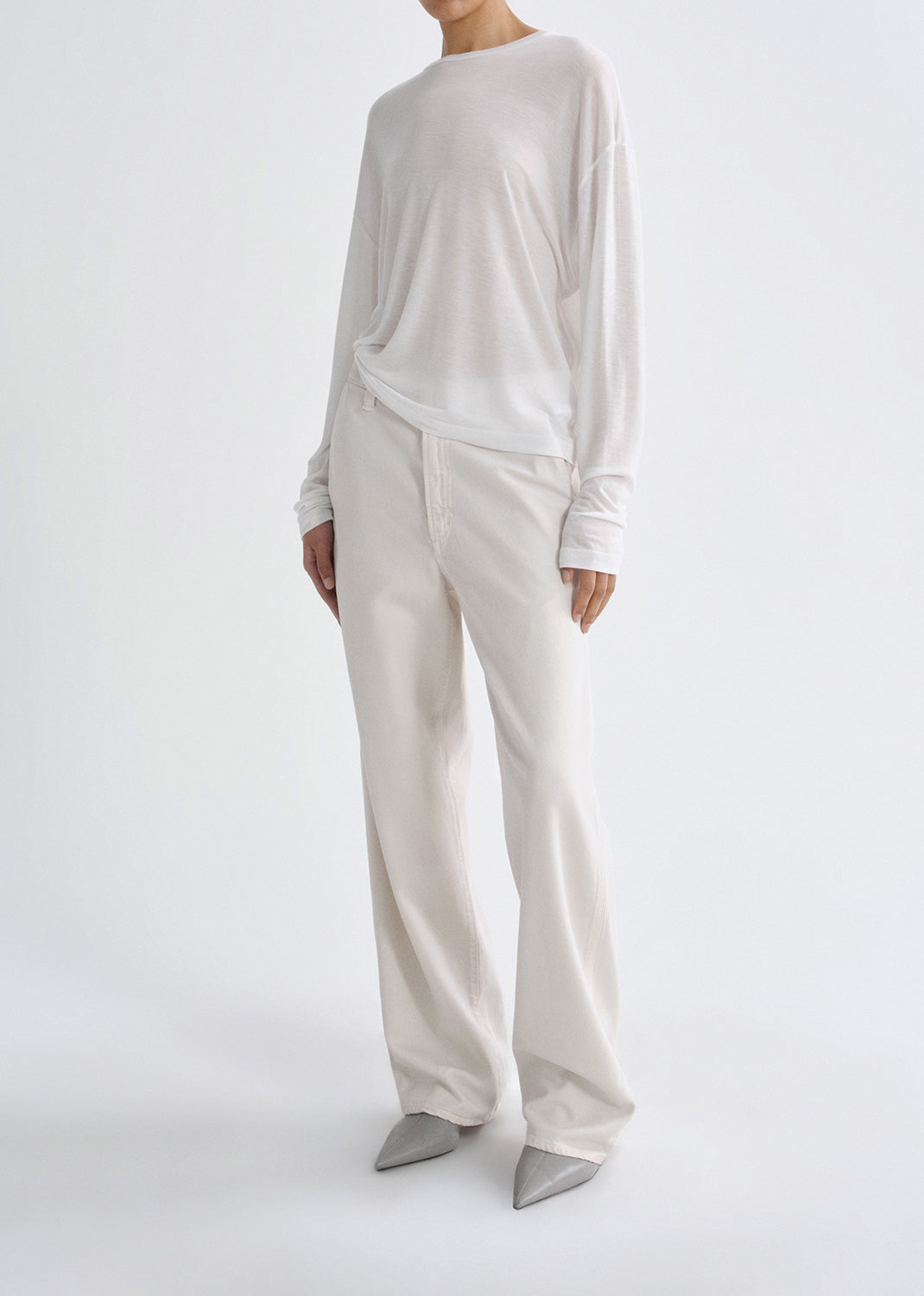 Person wearing white outfit on grey background