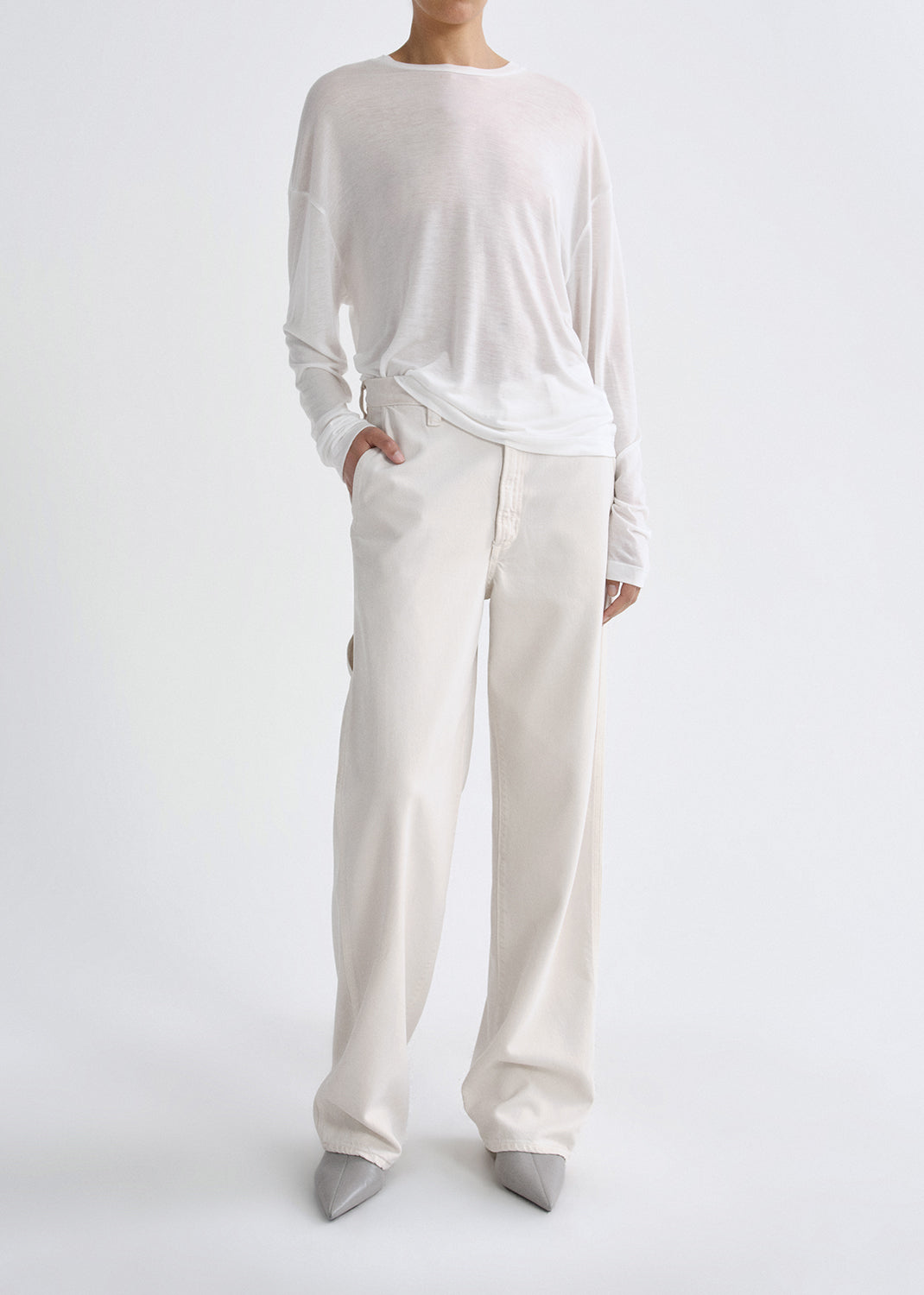 Person wearing white outfit on grey background