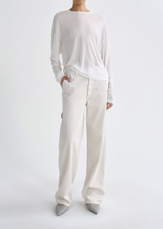 Person wearing white outfit on grey background