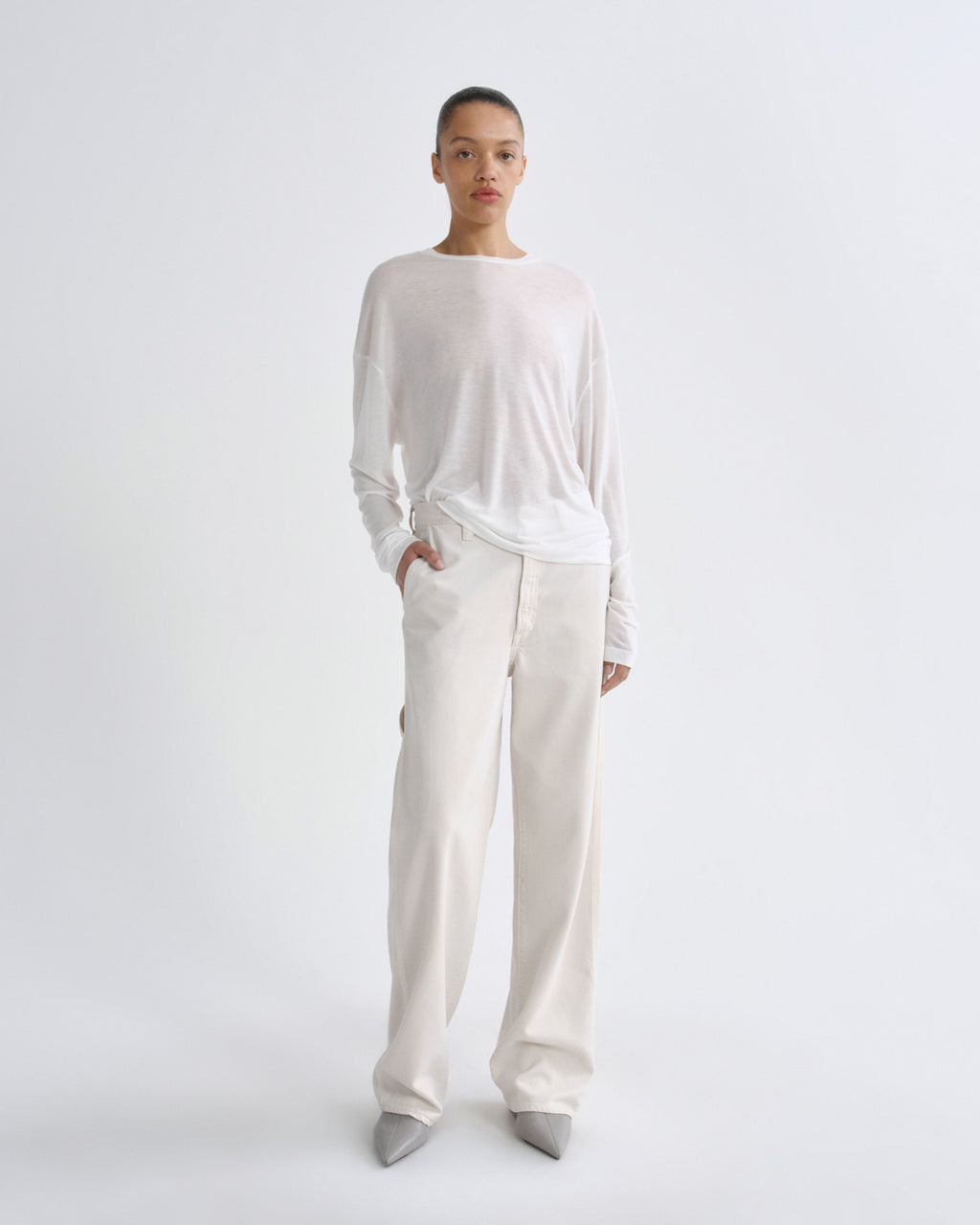 Person wearing a white outfit on a plain background
