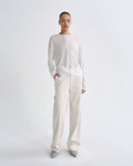 Person wearing a white outfit on a plain background