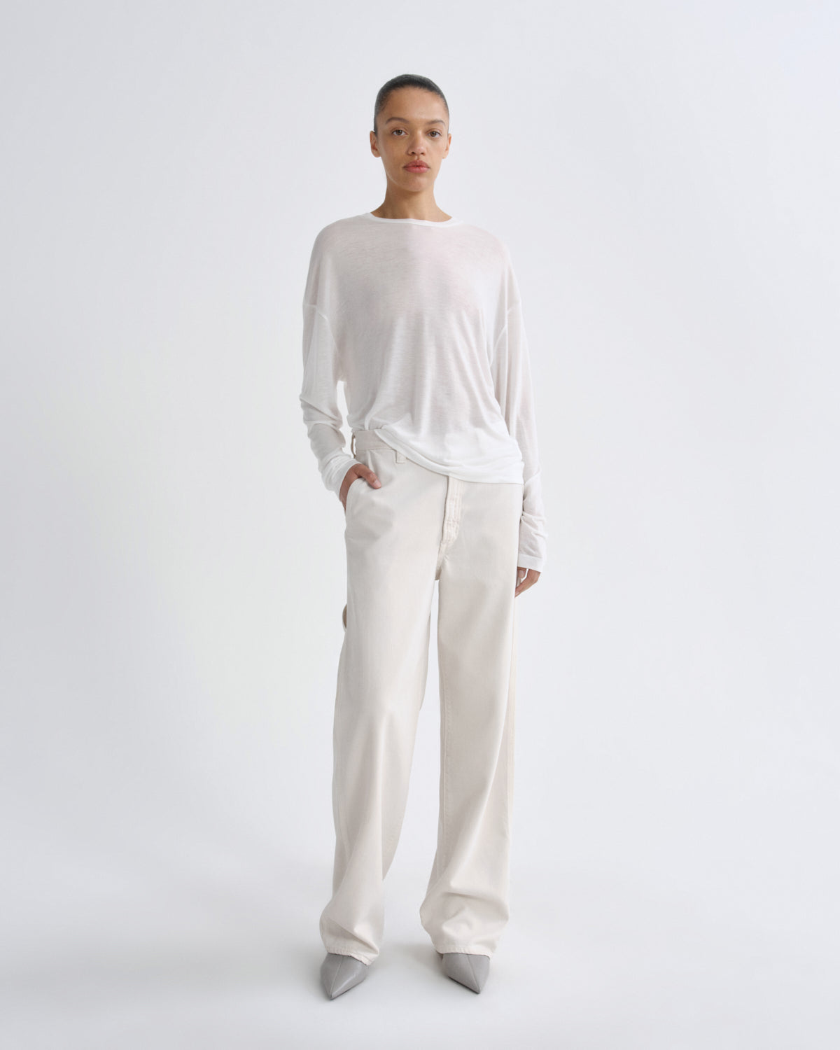 Person wearing a white outfit on a plain background