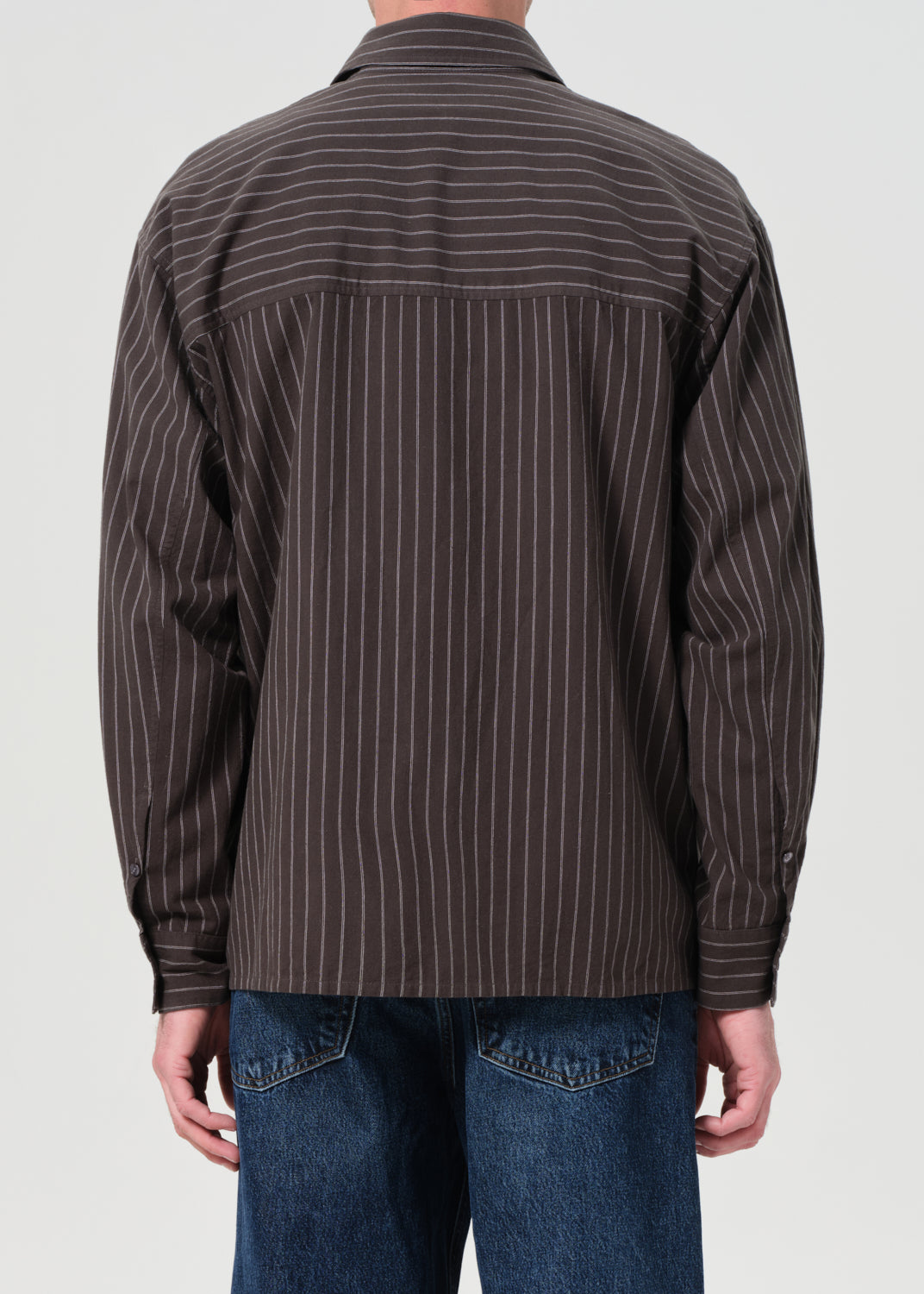 Brown pinstripe shirt worn by a person on a white background