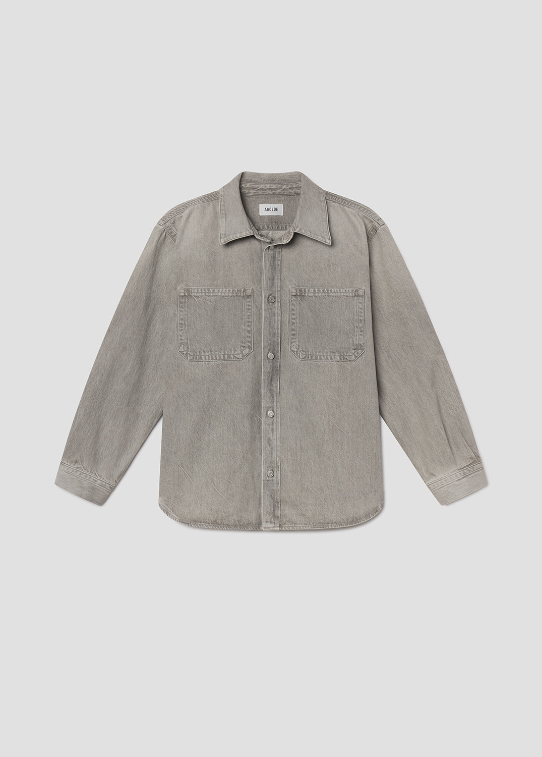 Flat lay of grey denim jacket on a light grey background