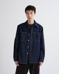 Man wearing a dark denim jacket on a white background